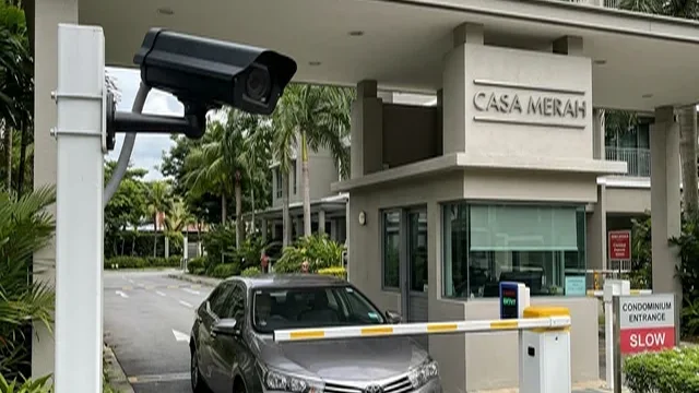 LPR camera reading a vehicle licence plate at a Singapore condominium barrier; the vehicle itself becomes the credential